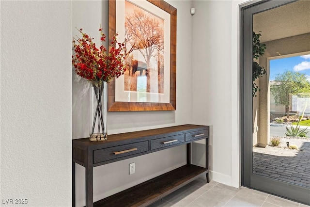 entryway with light tile patterned flooring