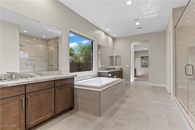 bathroom with visible vents, a sink, two vanities, a shower stall, and tile patterned floors