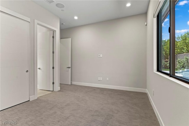 unfurnished bedroom featuring recessed lighting, carpet, and baseboards