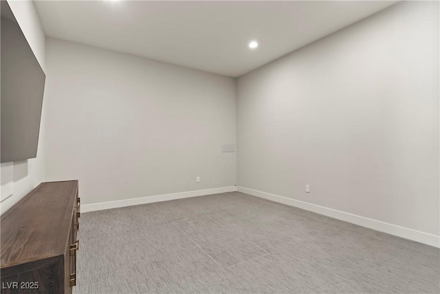 empty room featuring recessed lighting, baseboards, and carpet floors