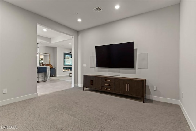 unfurnished living room with baseboards, recessed lighting, and carpet