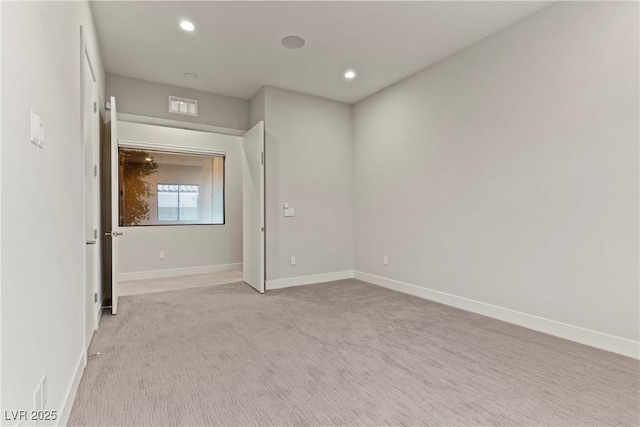spare room with visible vents, baseboards, recessed lighting, and carpet flooring