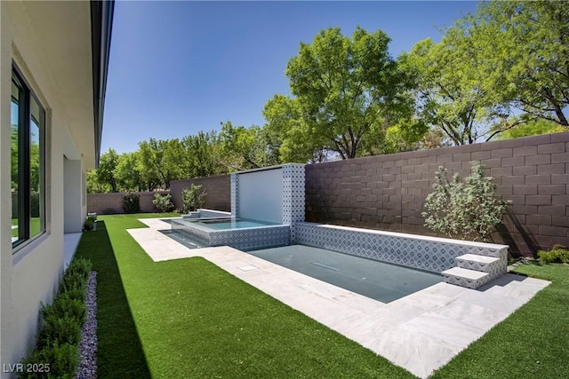 view of pool with a patio, an in ground hot tub, a fenced backyard, and a lawn