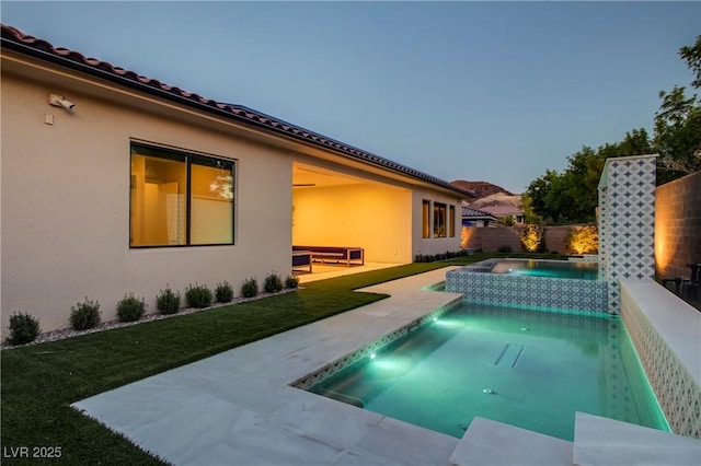 view of pool featuring a patio area, a yard, fence, an in ground hot tub, and a fenced in pool