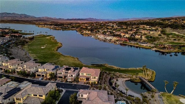 drone / aerial view featuring a water and mountain view and a residential view