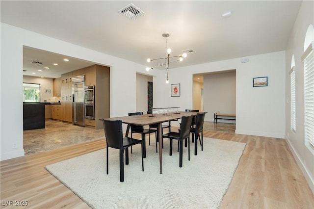 3007 La Mesa Dr, Henderson, NV 89014 - dining area featuring light wood-type flooring, visible vents, and an inviting chandelier