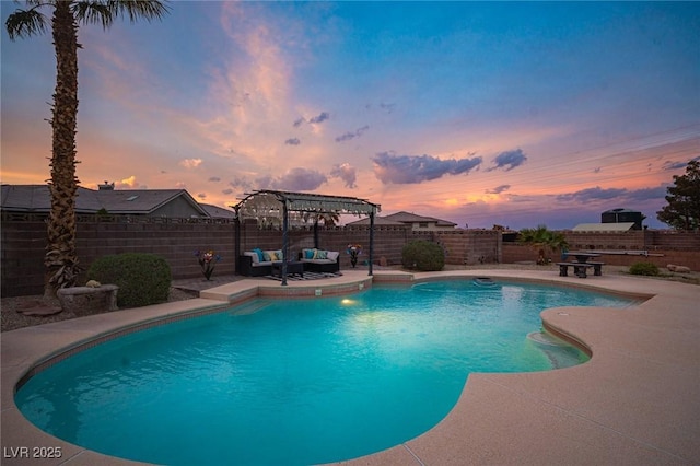 8610 Mohawk St, Las Vegas, NV 89139 - pool at dusk with a pergola, an outdoor hangout area, a patio, and a fenced backyard