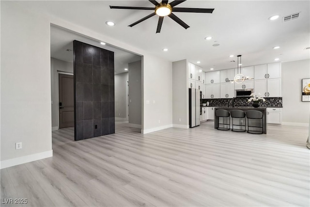 1185 Via Casa Palermo, Henderson, NV 89011 - living room with light wood finished floors, visible vents, a ceiling fan, and baseboards