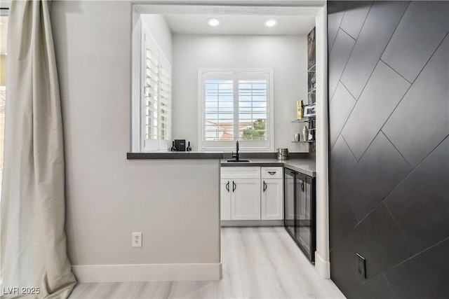 1185 Via Casa Palermo, Henderson, NV 89011 - bar featuring baseboards, a sink, and light wood-style flooring