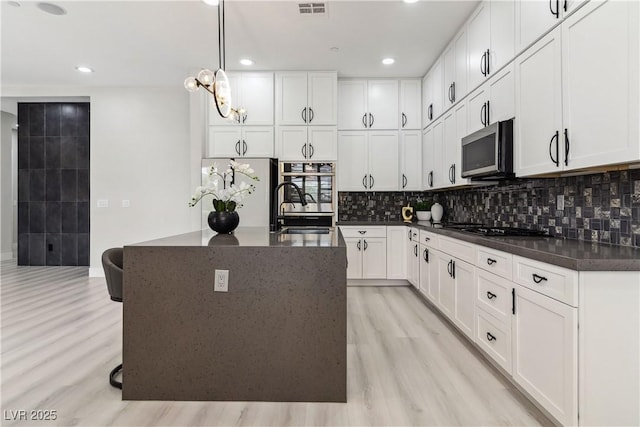 1185 Via Casa Palermo, Henderson, NV 89011 - kitchen with visible vents, stainless steel appliances, light wood-type flooring, and a sink