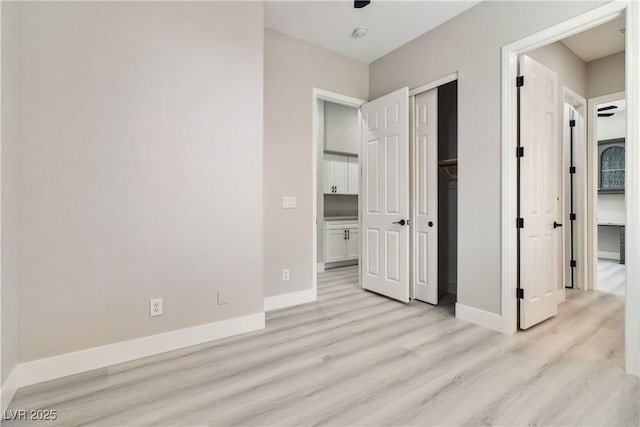 1185 Via Casa Palermo, Henderson, NV 89011 - unfurnished bedroom featuring baseboards, a closet, and light wood-style flooring