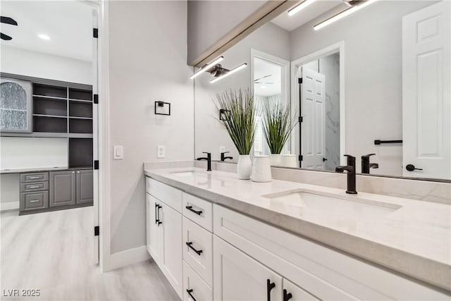 1185 Via Casa Palermo, Henderson, NV 89011 - bathroom with baseboards, wood finished floors, a sink, and double vanity