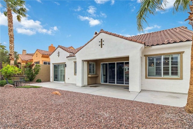 1185 Via Casa Palermo, Henderson, NV 89011 - rear view of house with a chimney, a tiled roof, stucco siding, and fence