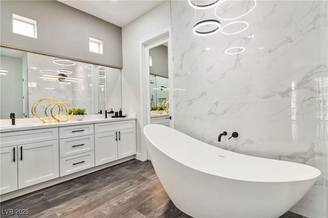 1185 Via Casa Palermo, Henderson, NV 89011 - bathroom with a freestanding bath, double vanity, a ceiling fan, and a sink