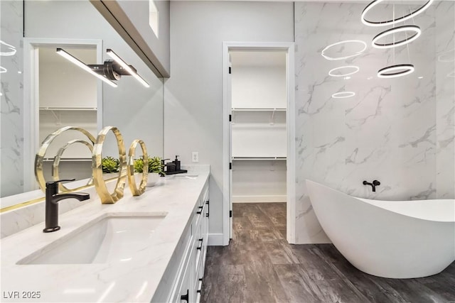 1185 Via Casa Palermo, Henderson, NV 89011 - full bath with a soaking tub, a sink, double vanity, a spacious closet, and wood finished floors