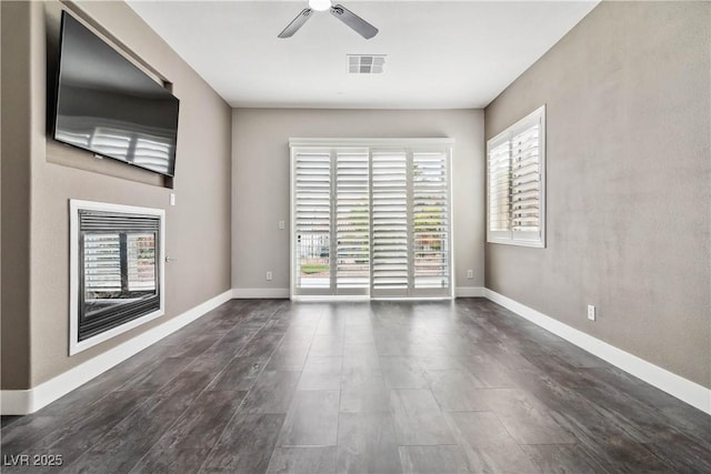 1185 Via Casa Palermo, Henderson, NV 89011 - unfurnished living room with baseboards, a ceiling fan, visible vents, and dark wood-style flooring