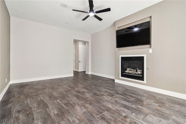 1185 Via Casa Palermo, Henderson, NV 89011 - unfurnished living room with ceiling fan, baseboards, and a glass covered fireplace
