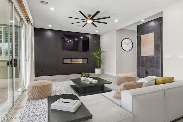 1185 Via Casa Palermo, Henderson, NV 89011 - living area with an accent wall, ceiling fan, baseboards, visible vents, and recessed lighting