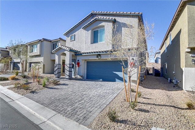 8351 Gold River Ct, Las Vegas, NV 89113 - view of front of house featuring stucco siding, an attached garage, driveway, and a tiled roof