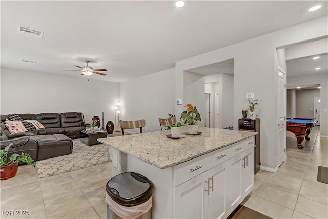 8351 Gold River Ct, Las Vegas, NV 89113 - kitchen with white cabinets, visible vents, pool table, and light tile patterned floors