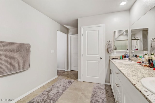 8351 Gold River Ct, Las Vegas, NV 89113 - bathroom with tile patterned floors, a sink, a shower with door, double vanity, and baseboards