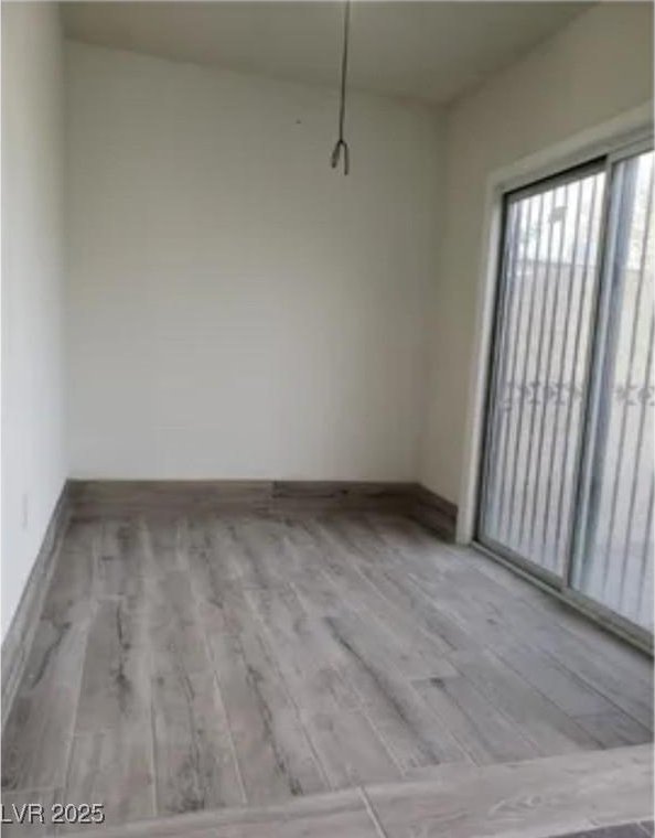 2525 Donna St Unit L, North Las Vegas, NV 89030 - unfurnished dining area featuring baseboards and wood finished floors