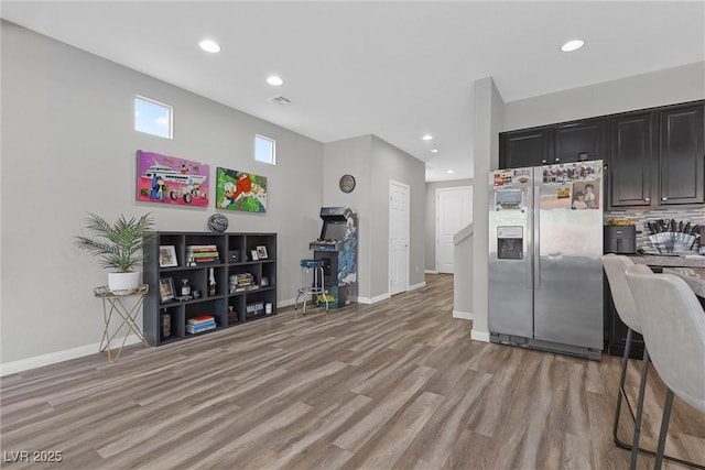 5419 Holding Ave, Las Vegas, NV 89139 - kitchen featuring stainless steel fridge with ice dispenser, baseboards, light wood-style floors, dark cabinets, and recessed lighting
