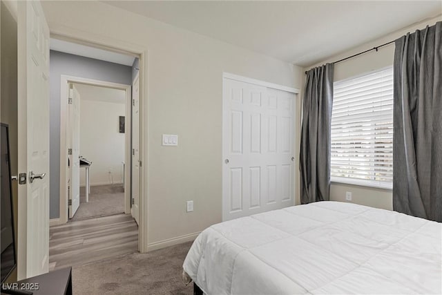 5419 Holding Ave, Las Vegas, NV 89139 - bedroom with a closet, carpet flooring, baseboards, and wood finished floors
