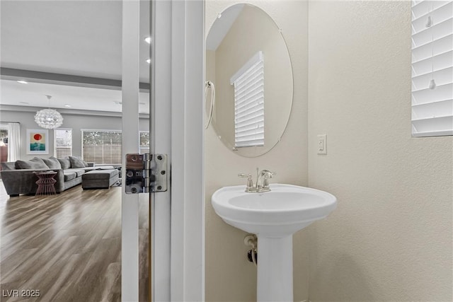 5419 Holding Ave, Las Vegas, NV 89139 - bathroom with a sink, a notable chandelier, and wood finished floors