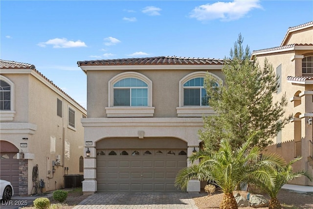 5419 Holding Ave, Las Vegas, NV 89139 - view of front of home with an attached garage, central air condition unit, decorative driveway, and stucco siding