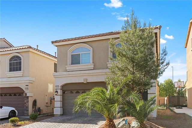 5419 Holding Ave, Las Vegas, NV 89139 - mediterranean / spanish-style home with an attached garage, stucco siding, a tile roof, and decorative driveway