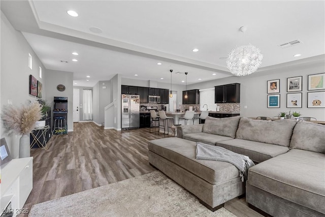 5419 Holding Ave, Las Vegas, NV 89139 - living room featuring a chandelier, wood finished floors, visible vents, and recessed lighting