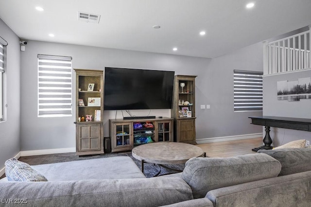 living area featuring visible vents, baseboards, and recessed lighting