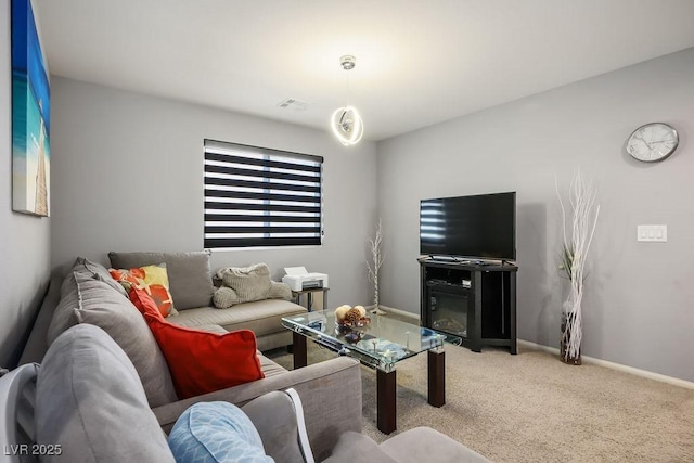 living room with visible vents, baseboards, and carpet