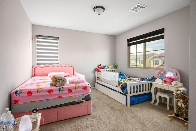 carpeted bedroom featuring visible vents