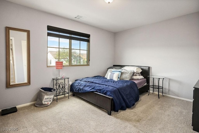 bedroom with carpet floors, baseboards, and visible vents