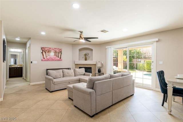living room with ceiling fan, visible vents, recessed lighting, light tile patterned flooring, and baseboards