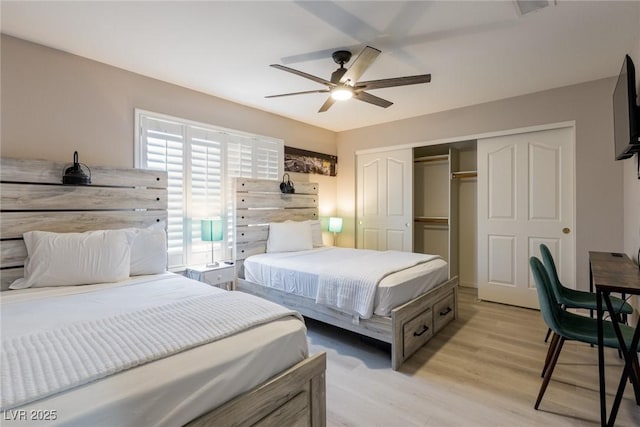 bedroom featuring light wood-type flooring, a closet, and a ceiling fan