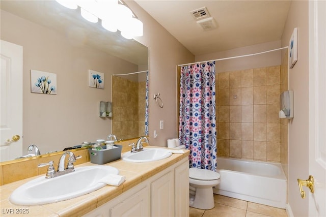 bathroom with tile patterned floors, visible vents, a sink, and toilet