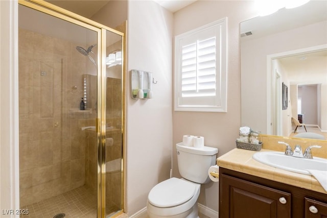 bathroom with toilet, vanity, visible vents, and a stall shower
