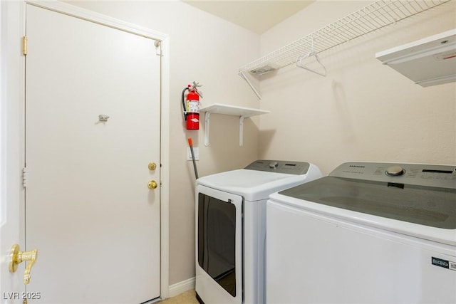 laundry area featuring separate washer and dryer and laundry area