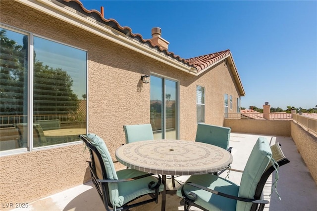 view of patio / terrace featuring outdoor dining space and a balcony