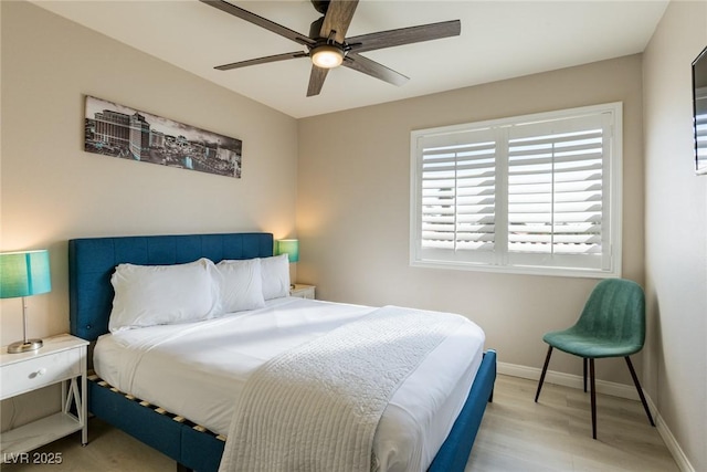 bedroom with ceiling fan, baseboards, and wood finished floors