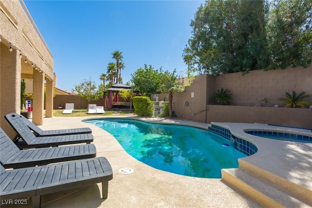 view of pool with a patio, a fenced backyard, a fenced in pool, and an in ground hot tub