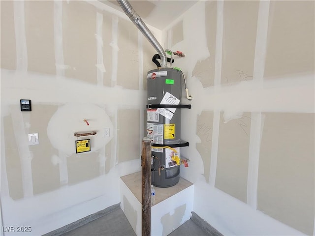 utility room featuring strapped water heater