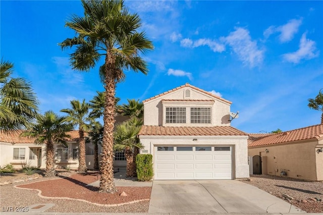 view of front of property featuring a garage, driveway, stucco siding, and a tile roof