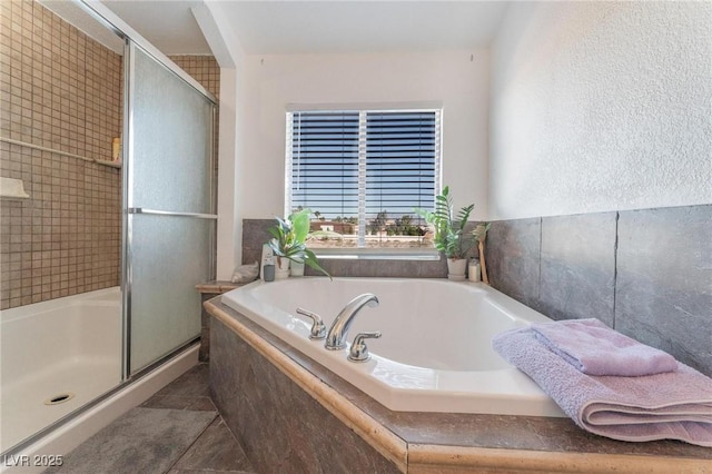 full bathroom with tile patterned floors, a shower stall, and a garden tub