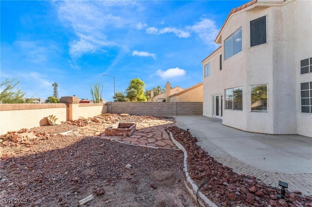 view of yard with a fenced backyard and a patio