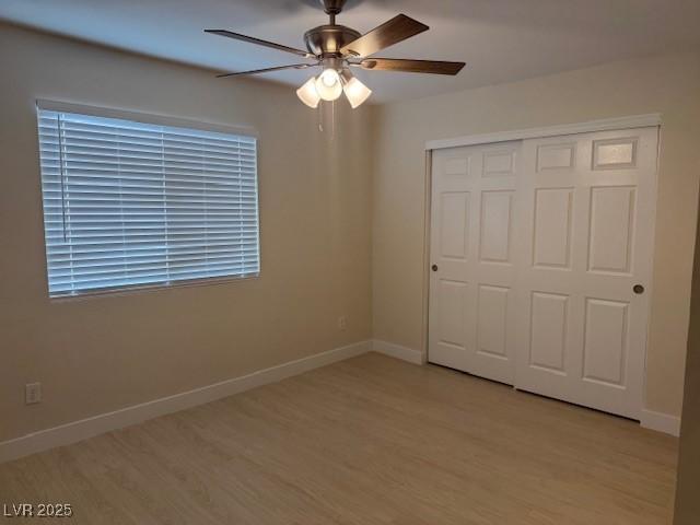 432 Anchor St, Las Vegas, NV 89110 - unfurnished bedroom featuring a closet, baseboards, light wood finished floors, and a ceiling fan