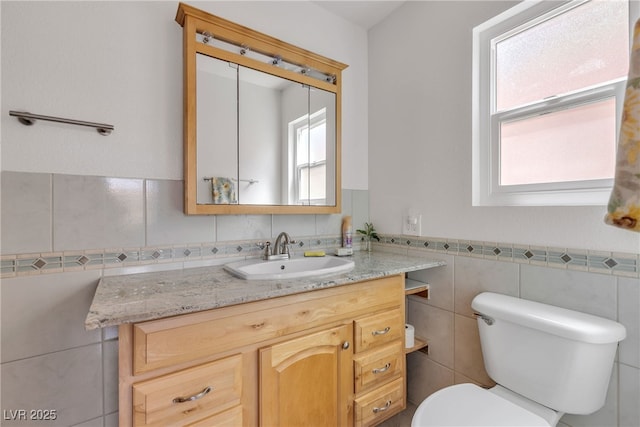 468 Potomac St, Henderson, NV 89015 - bathroom featuring vanity, toilet, tile walls, and wainscoting